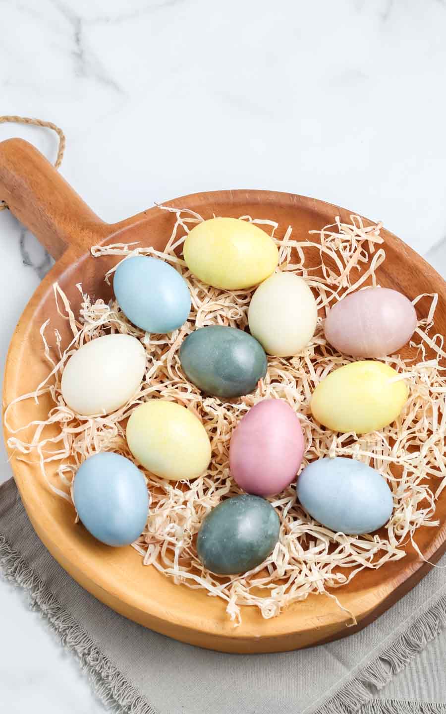 a wooden board with Eastern eggs on display.