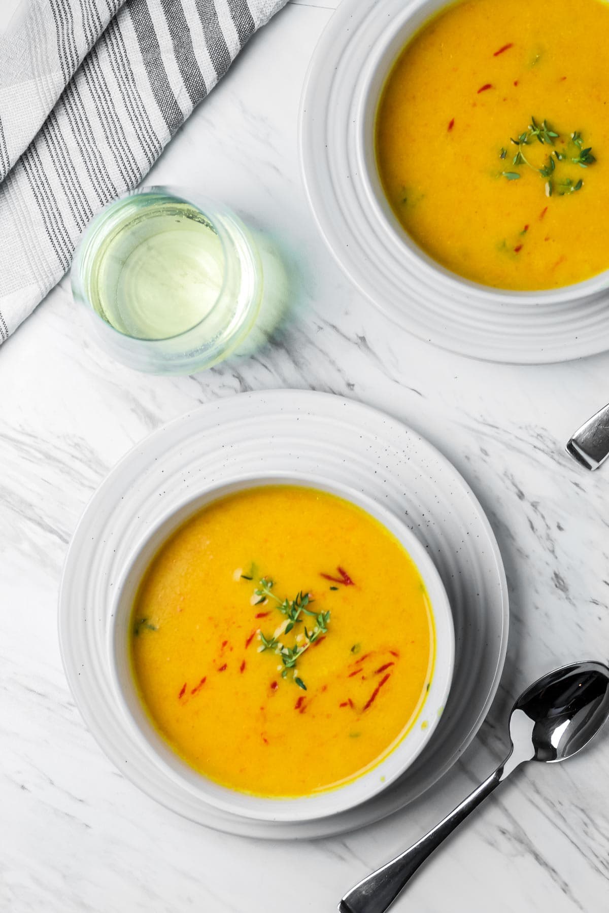 Two bowls of butternut and shrimp soup.