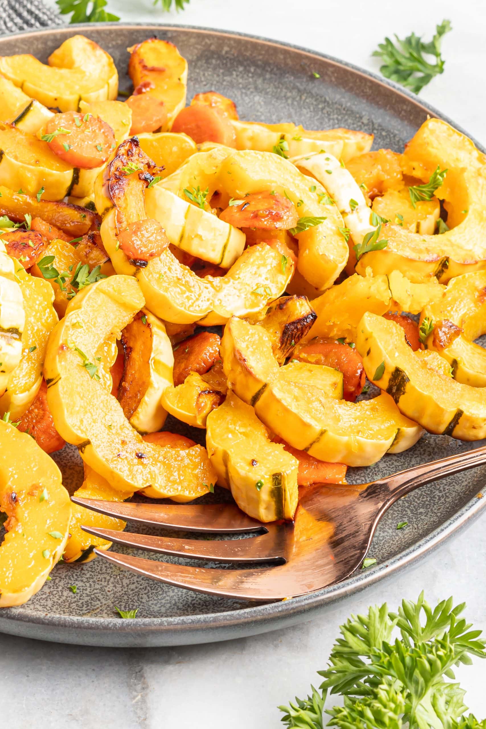 A platter of roasted squash and carrots in a miso and maple glaze.