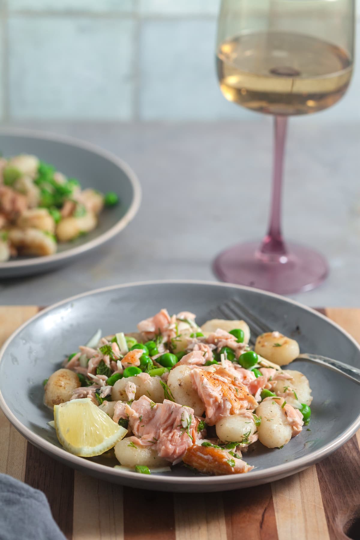 Plated gnocchi with salmon and peas. 