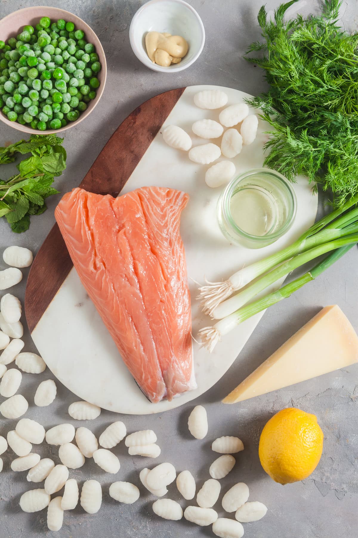 Ingredients to make skillet gnocchi with salmon and peas. 