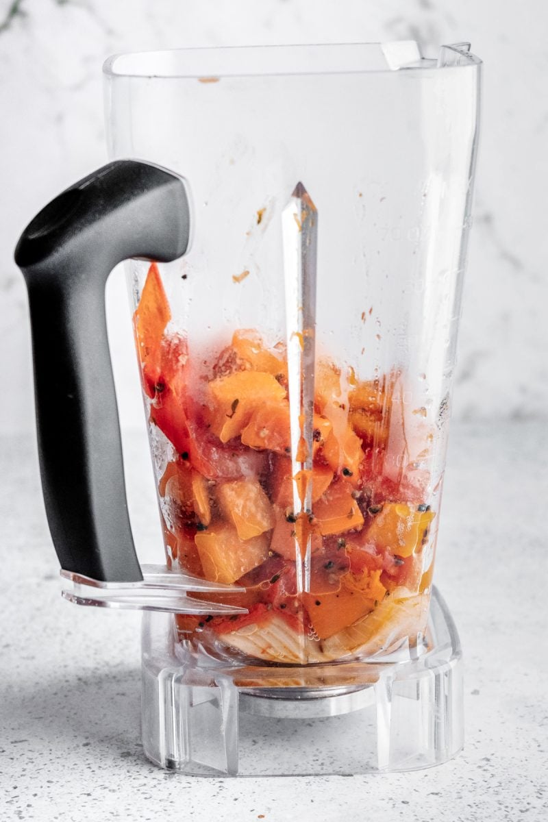 The roasted vegetables in a blender. 