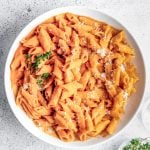 A serving bowl filled with butternut squash pasta.