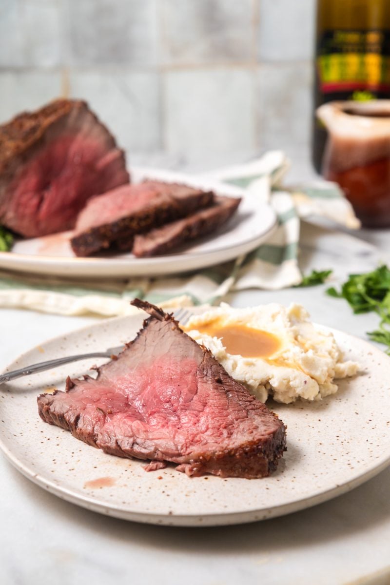 A plated roast beef dinner with mashed potatoes and gravy.